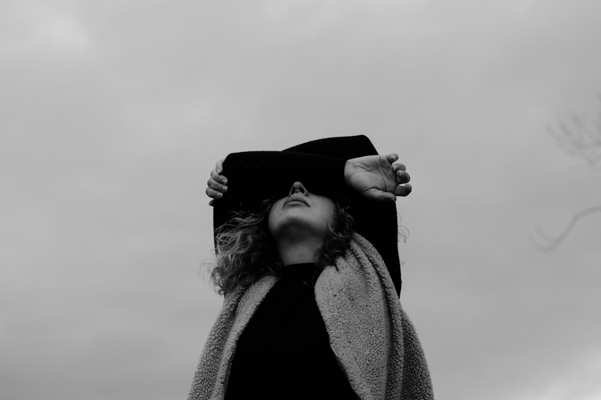grayscale photo of woman in coat