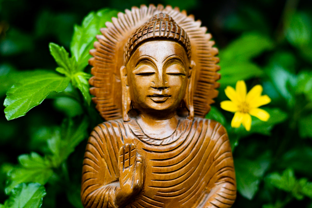 gold buddha statue in close up photography