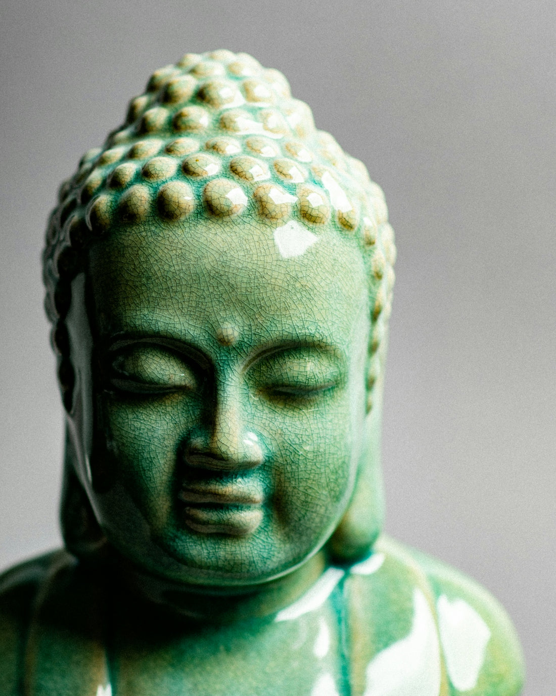 A statue of a buddha with eyes closed