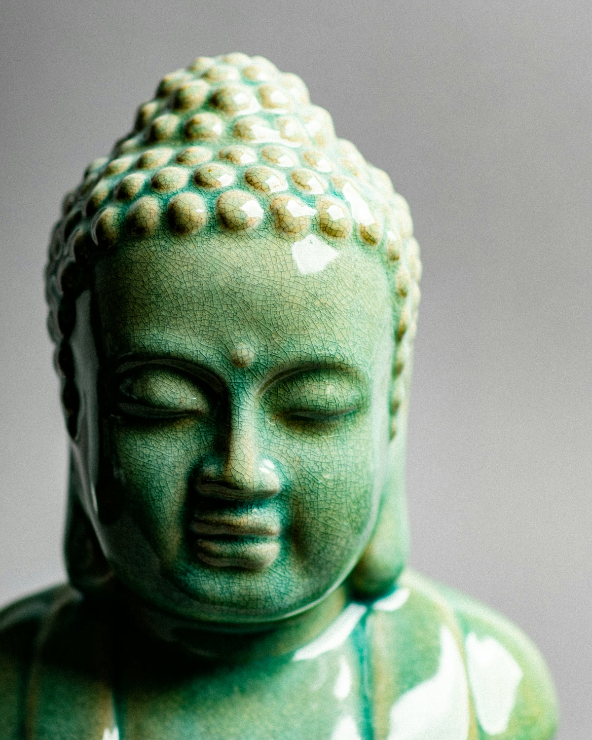 A statue of a buddha with eyes closed